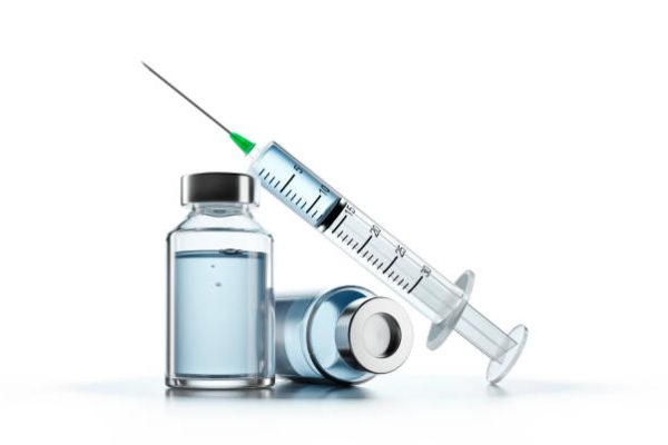 Covid-19, Coronavirus vaccine in vial with syringe on white background.